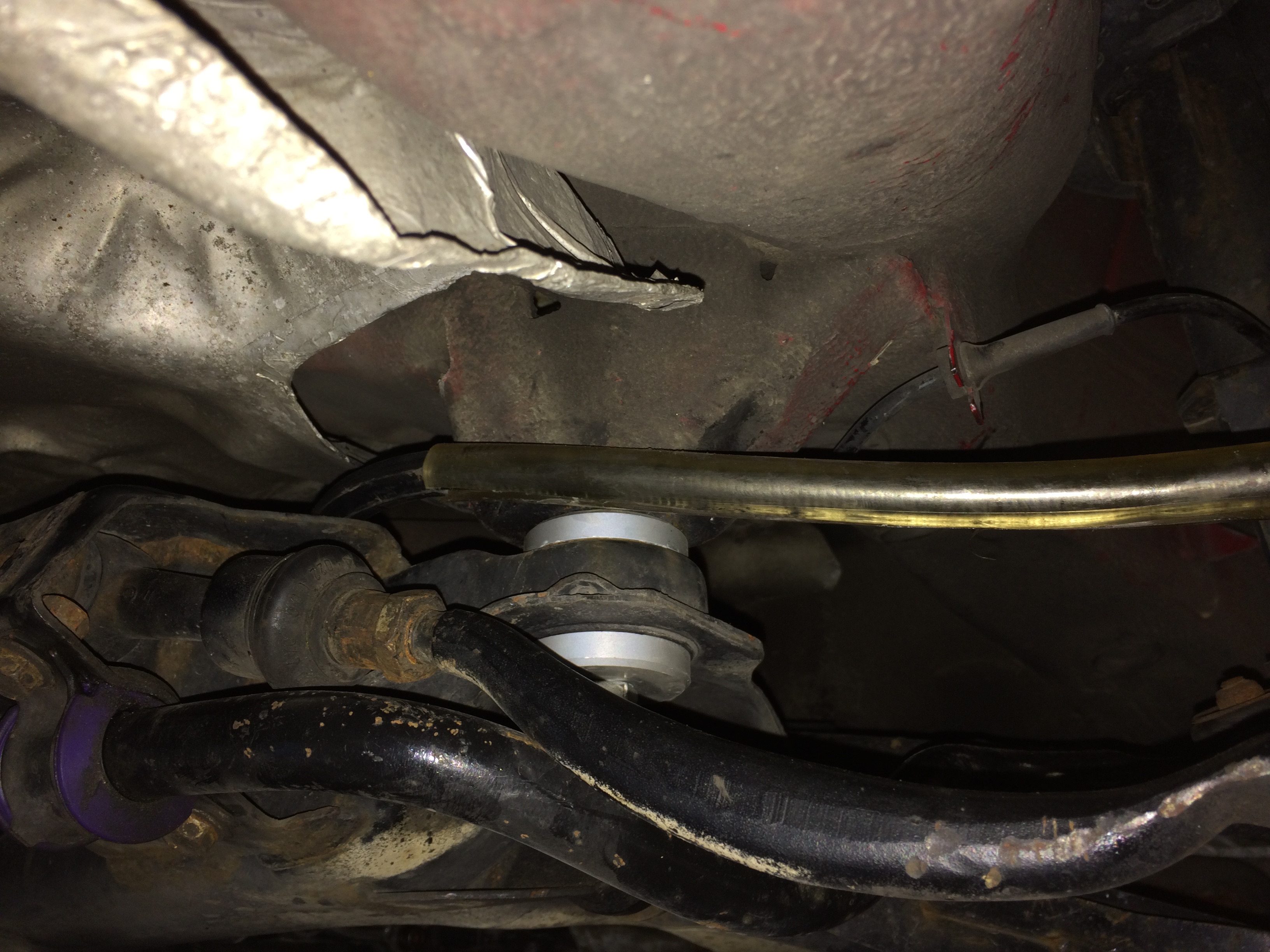 Cable routed Behind back end of subframe. Plastic tubing cut to fit over new parking brake cable for protection.